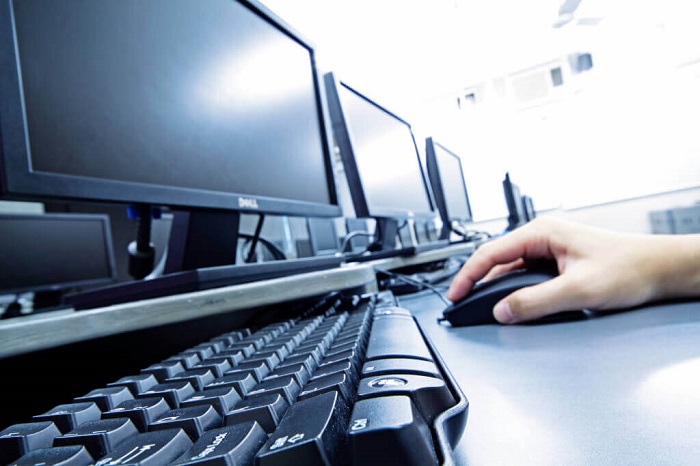 Sitting at a computer Man at a computer.