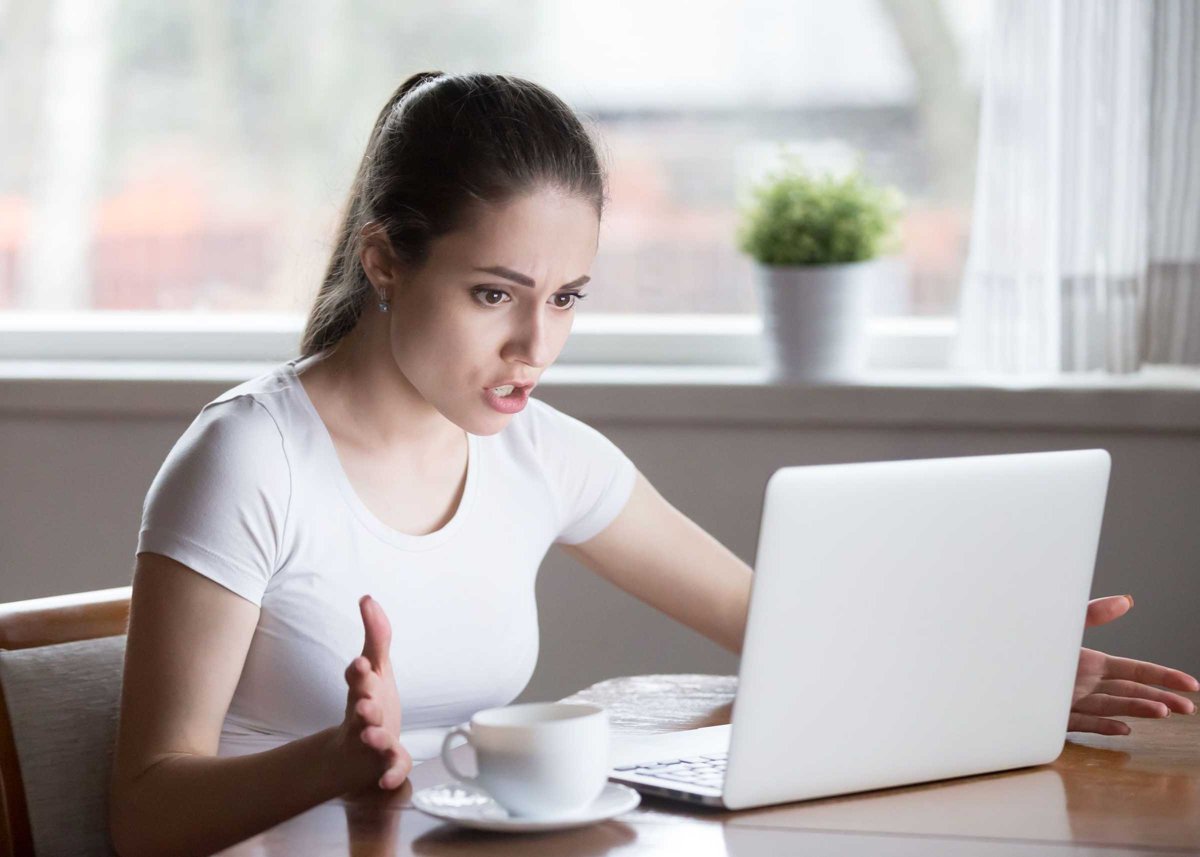 Indignant angry female has problems with laptop