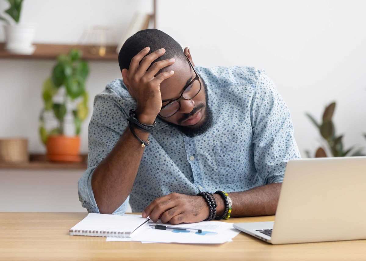 Tired depressed bored african businessman frustrated by business failure