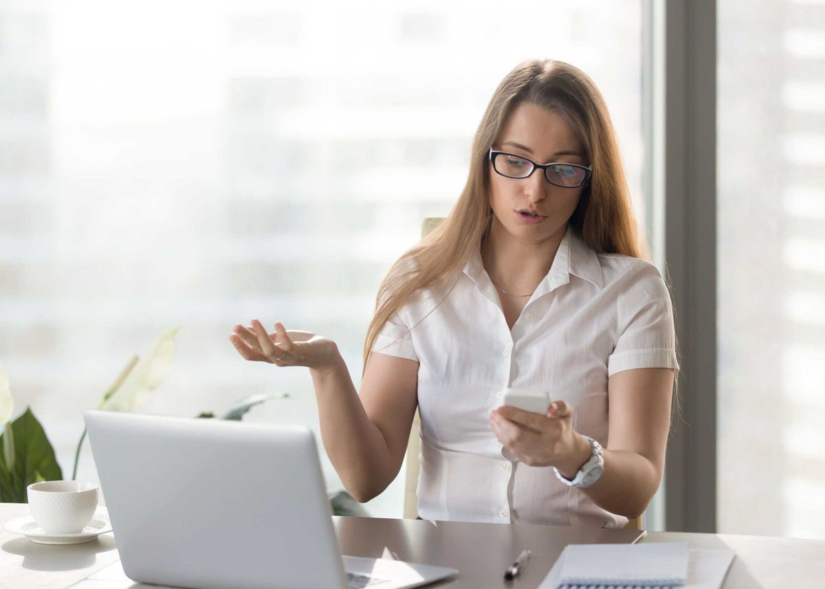 Indignant businesswoman having problem with not working smartpho