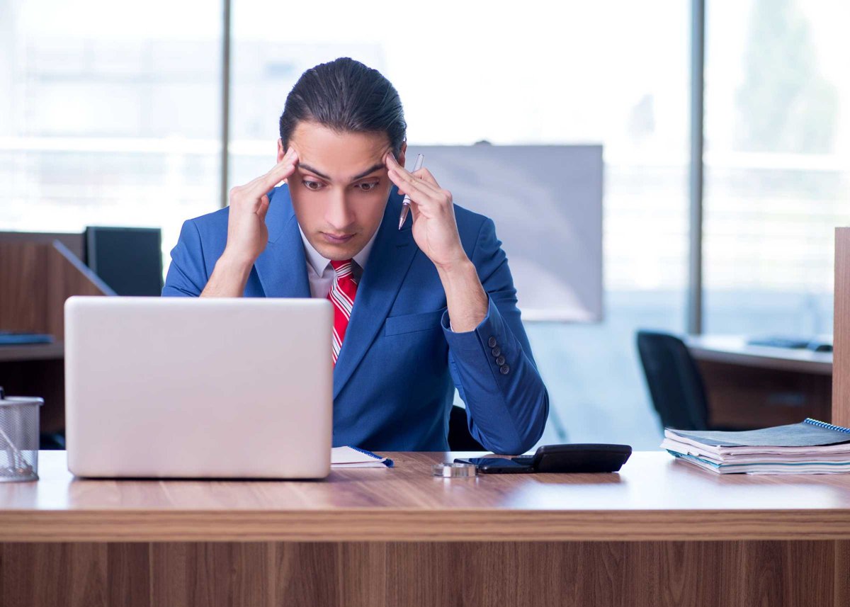 Young handsome businessman sitting in the office