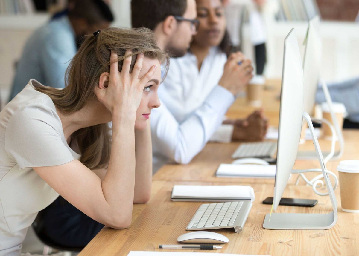 Stressed female employee having computer problem at work