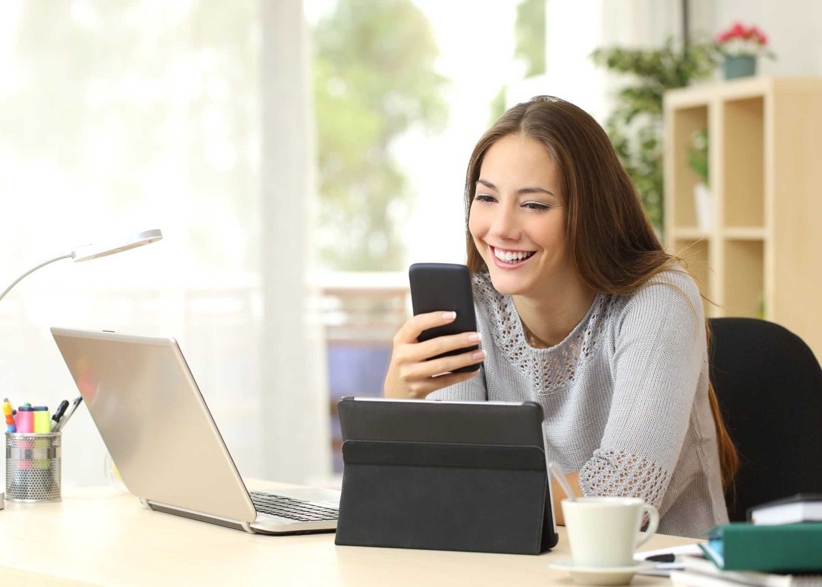 Woman using multiple devices at home