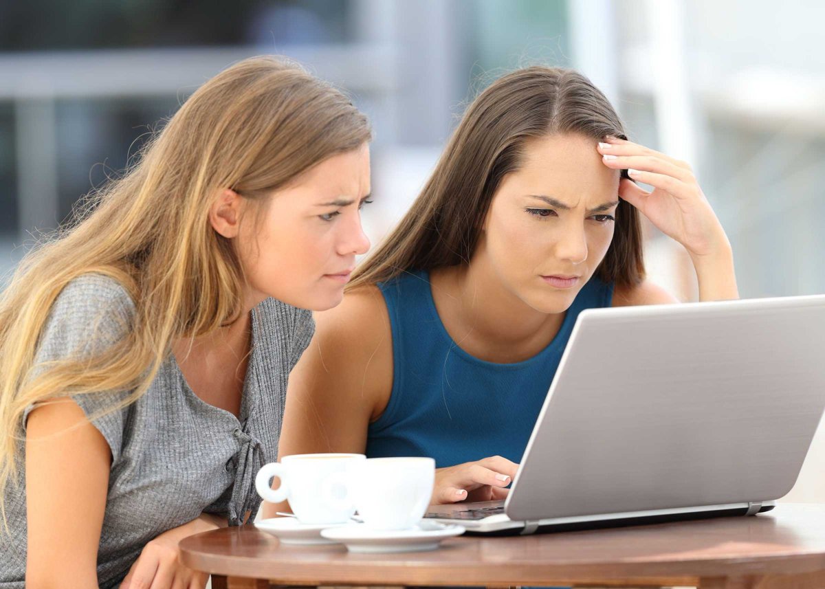 Two worried friends watching media content on line