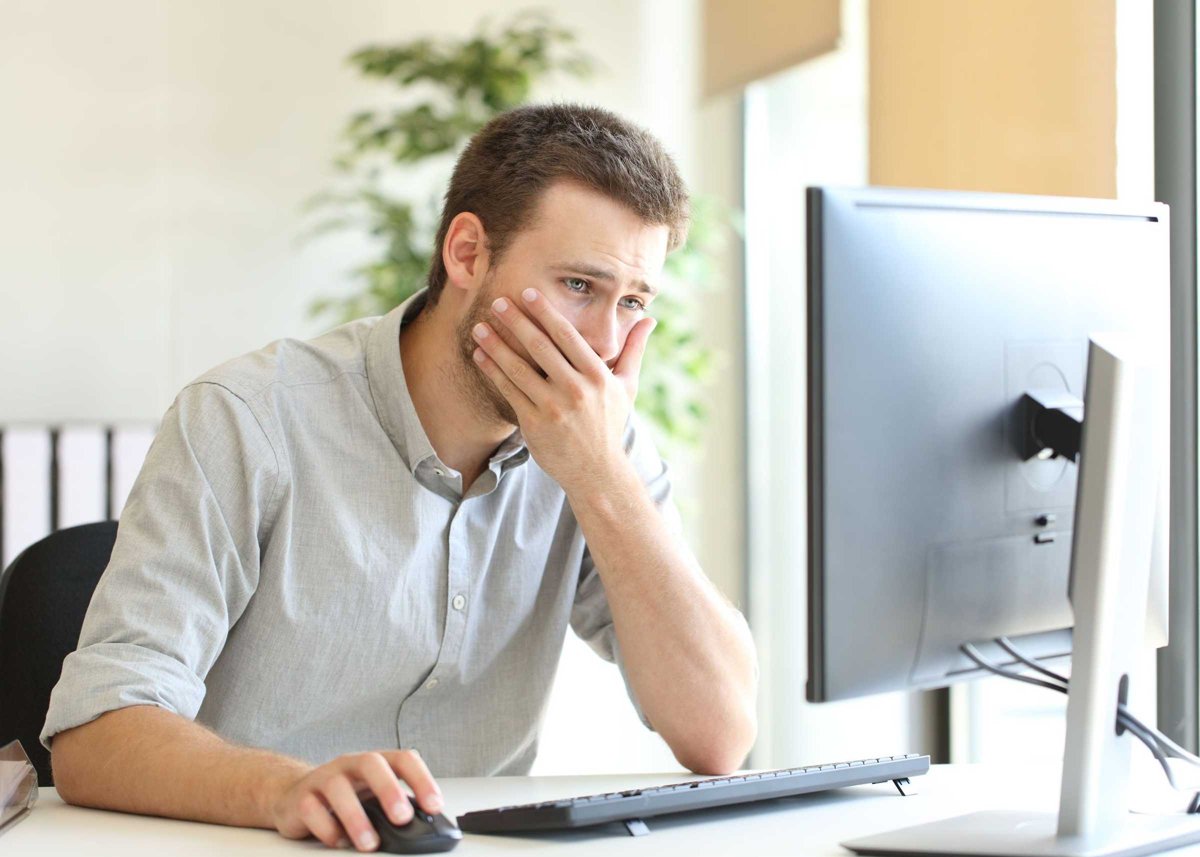Worried businessman working online