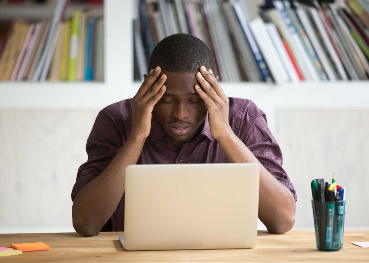 Frustrated black man feeling depressed after fail sitting with l