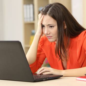 Sad and worried entrepreneur with laptop