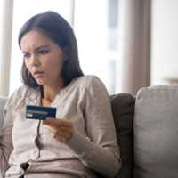 Woman using online banking having problem with blocked credit card