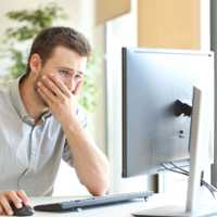 Worried businessman working online