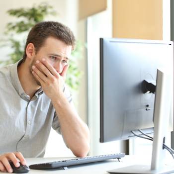 Worried businessman working online