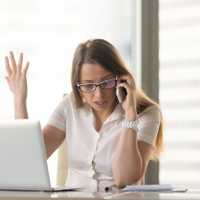 Disgruntled angry businesswoman arguing on cell phone sitting at