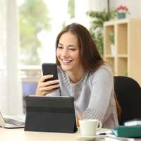 Woman using multiple devices at home