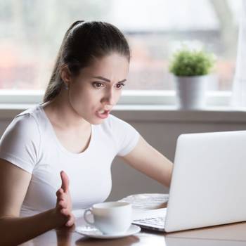 Indignant angry female has problems with laptop