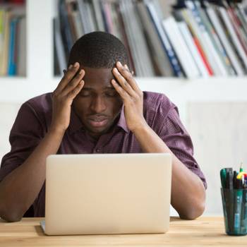 Frustrated black man feeling depressed after fail sitting with l