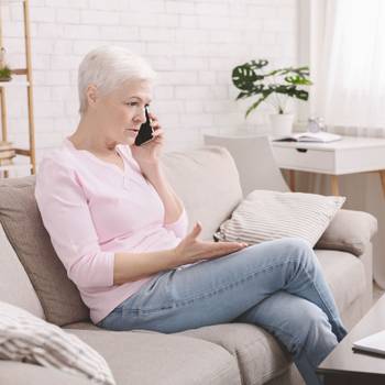 Angry senior woman complaining about problems with laptop