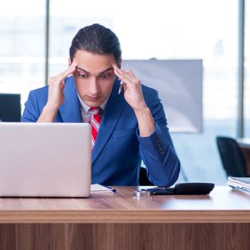 Young handsome businessman sitting in the office